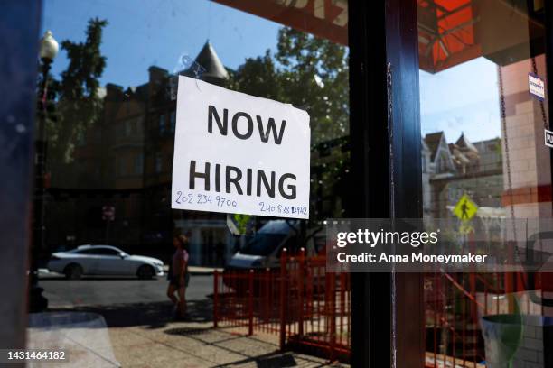 Now Hiring" sign is displayed on a storefront in Adams Morgan Neighborhood on October 07, 2022 in Washington, DC. The Labor Department announced that...