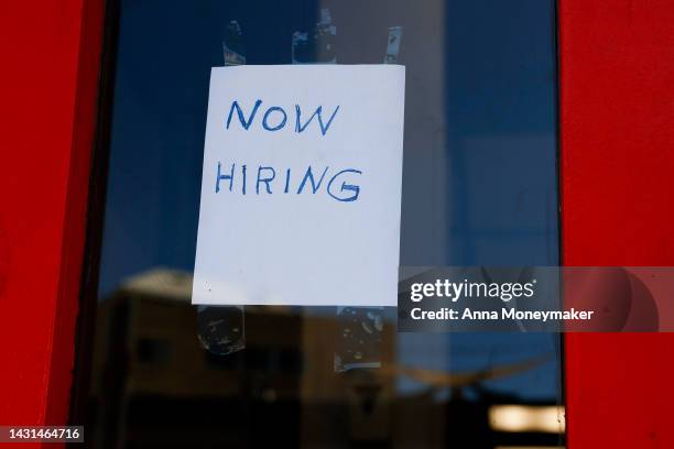 Now Hiring" sign is displayed on a storefront in Adams Morgan Neighborhood on October 07, 2022 in Washington, DC. The Labor Department announced that...