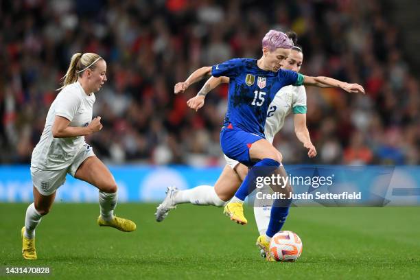 Megan Rapinoe of United States battles for possession with Lucy Bronze and Beth Mead of England during the Women's International Friendly match...