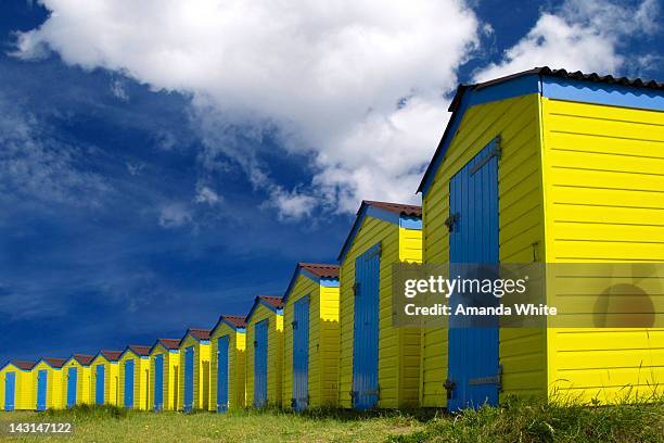 yellow and blue beach huts - amanda blue stock pictures, royalty-free photos & images