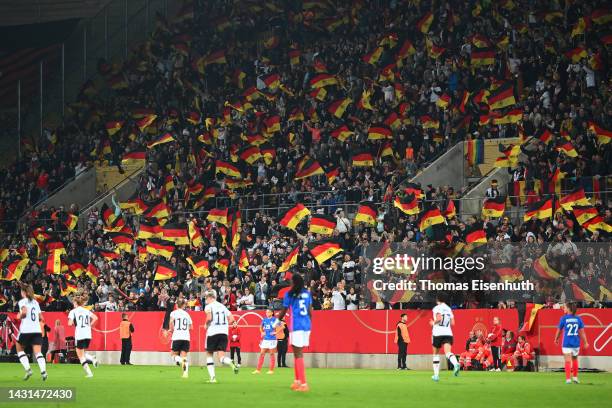 Germany fans celebrate after Alexandra Popp of Germany scores their team's first goal during the international friendly match between Germany Women's...