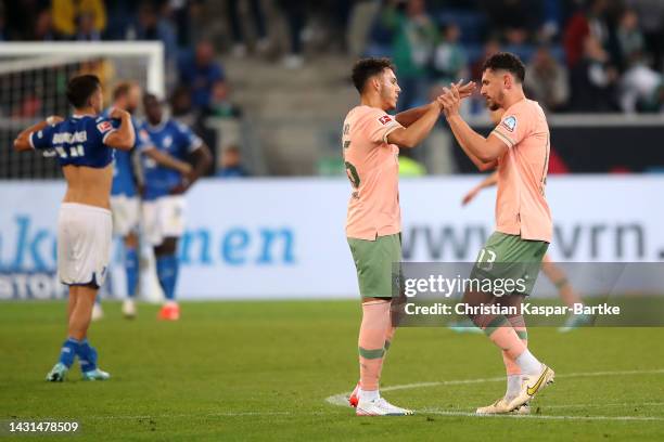 Lee Buchanan and Milos Veljkovic of Werder Bremen celebrate after the Bundesliga match between TSG Hoffenheim and SV Werder Bremen at PreZero-Arena...