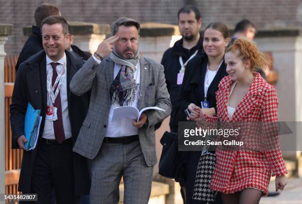 Luxembourg Prime Minister Xavier Bettel makes a gesture while reading a document and walking with colleagues following an informal summit of the...