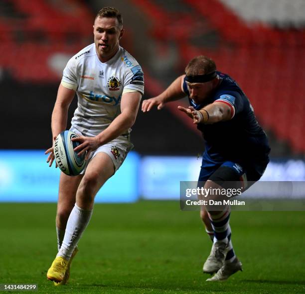 Rory O'Loughlin of Exeter Chiefs gets past the tackle from Jake Woolmore of Bristol Rugby during the Gallagher Premiership Rugby match between...