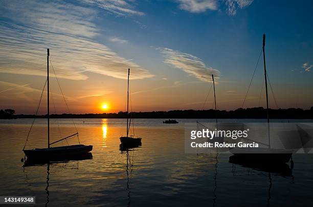 boats in sea at sunset - rolour garcia stock pictures, royalty-free photos & images