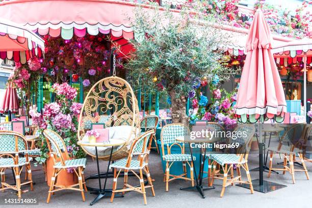 a charming and romantic café with flowers in paris - montparnasse stock pictures, royalty-free photos & images