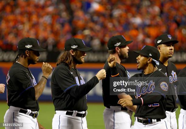 Francisco Lindor of the New York Mets is greeted by teammates during player introductions before game one of the NL Wild Card Series at Citi Field on...