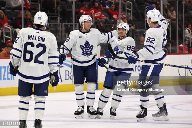 Rasmus Sandin of the Toronto Maple Leafs celebrates his first period goal with teammates while playing the Detroit Red Wings at Little Caesars Arena...