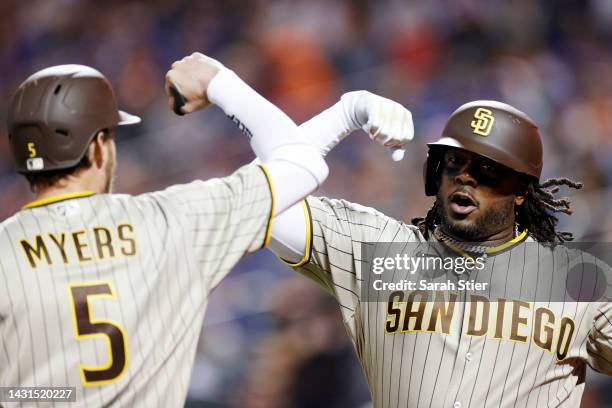 Josh Bell celebrates with Wil Myers of the San Diego Padres after hitting a two-run home run during the first inning of Game One of the NL Wild Card...