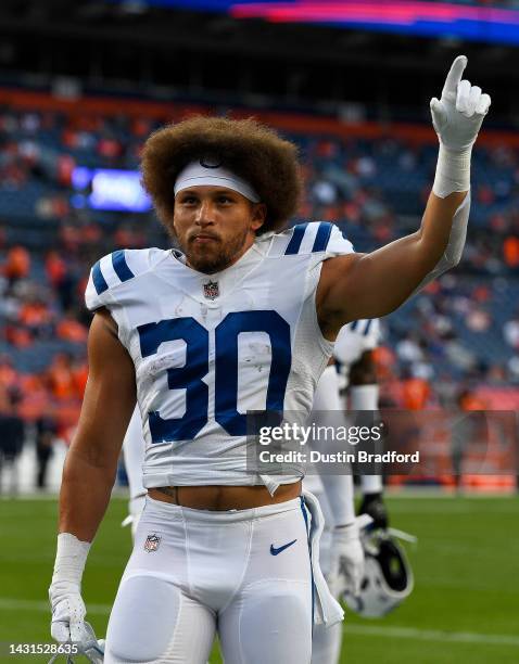 Running back Phillip Lindsay of the Indianapolis Colts walks off the field after warming up before a game against the Denver Broncos at Empower Field...