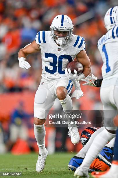 Running back Phillip Lindsay of the Indianapolis Colts carries the ball against the Denver Broncos in a game at Empower Field at Mile High on October...