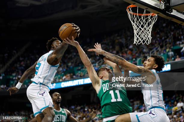 Terry Rozier of the Charlotte Hornets blocks a shot attempt from Payton Pritchard of the Boston Celtics during the third quarter of the game at...