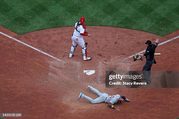 Edmundo Sosa of the Philadelphia Phillies celebrates after beating a tag at home by Yadier Molina of the St. Louis Cardinals during the ninth inning...