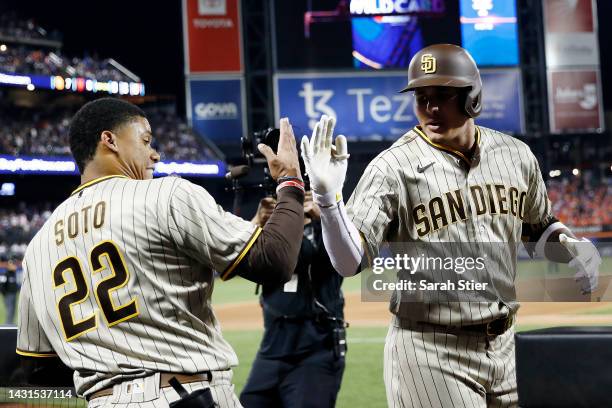 Manny Machado celebrates with Juan Soto of the San Diego Padres after hitting a solo home run during the fifth inning of Game One of the NL Wild Card...