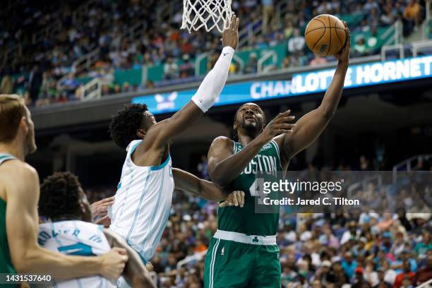 Noah Vonleh of the Boston Celtics attempts a shot against Jalen McDaniels of the Charlotte Hornets during the third quarter of the game at Greensboro...