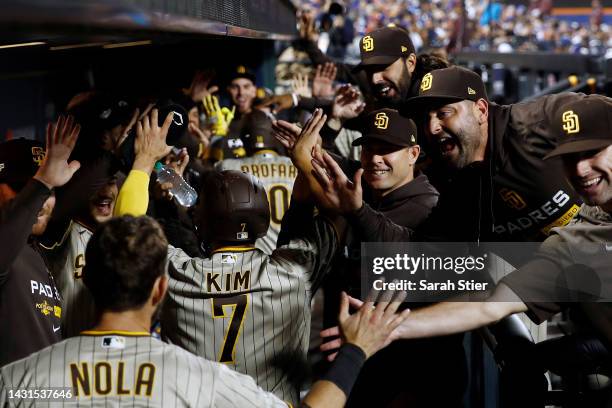 The San Diego Padres dugout celebrates with Austin Nola, Ha-Seong Kim, and Jurickson Profar after Profar's three-run home run during the fifth inning...