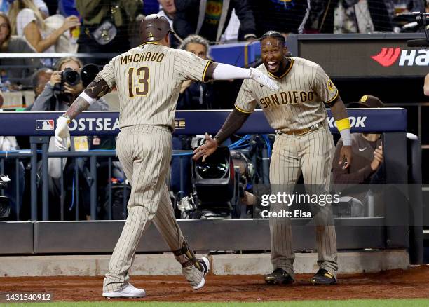 Manny Machado of the San Diego Padres is congratulated by teammate Jurickson Profar after Machado hit a solo home run in the fifth inning against the...