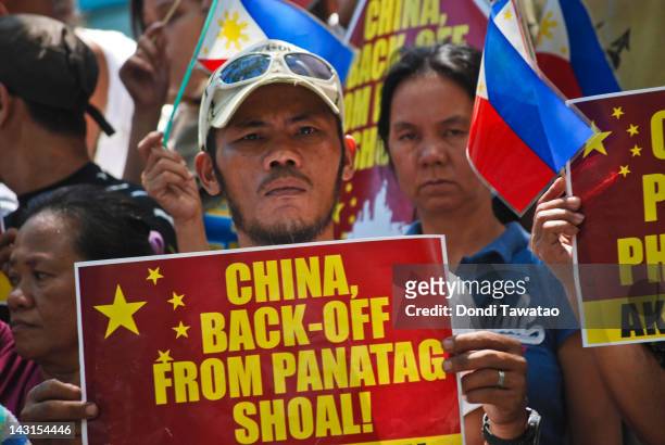 Filipino protestors stage a rally demanding China pull out of the contested Scarborough Shoal in the South China Sea outside the Chinese Embassy in...