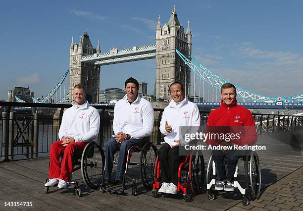 Josh Cassidy of Canada, Ernst van Dyk of South Africa, Masazumi Soejima of Japan and David Weir of Great Britain pose in front of Tower Bridge during...