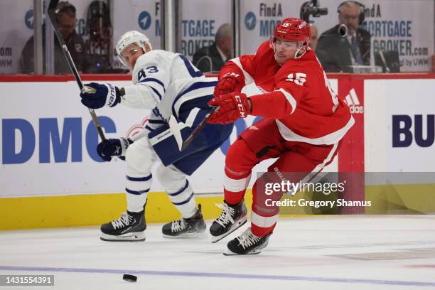 Jakub Vrana of the Detroit Red Wings hets around Kyle Clifford of the Toronto Maple Leafs during the second periodat Little Caesars Arena on October...