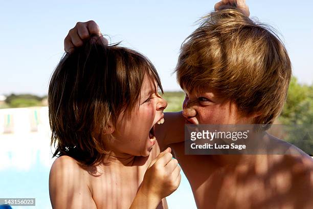 summer holiday - child pulling hair stock pictures, royalty-free photos & images
