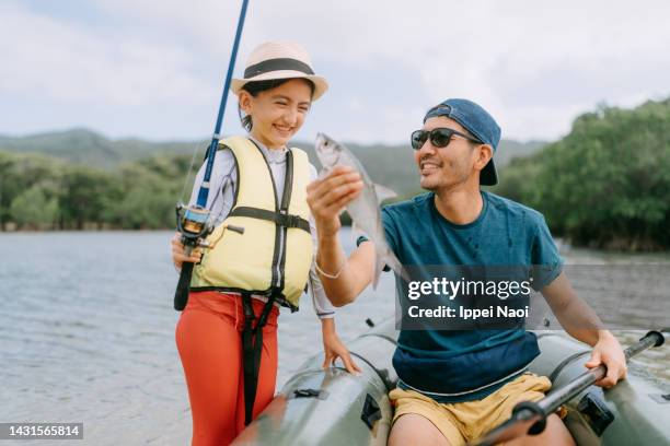 father and daughter with fish that they caught from kayak - rowing boat stock pictures, royalty-free photos & images