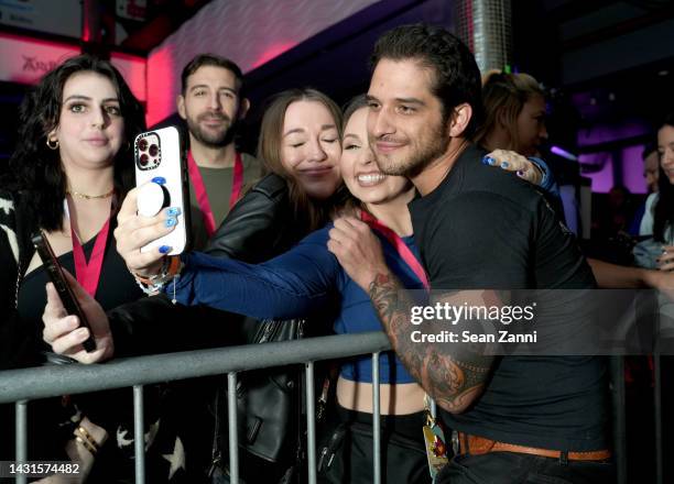 Tyler Posey poses for a photo with fans during Fandom Party New York on October 07, 2022 in New York City.