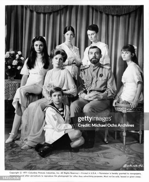 Candace Glendenning, Janet Suzman, Roderic Noble, Lynne Frederick, Ania Marson, Michael Jayston, and Fiona Fullerton sitting for family portrait in a...