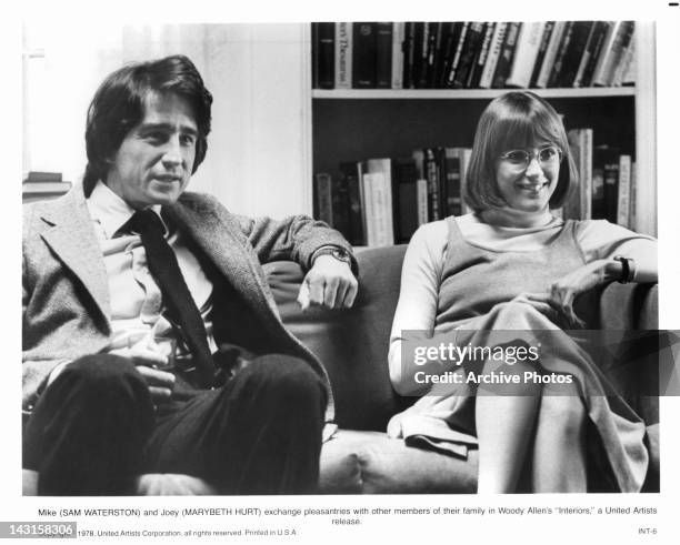 Sam Waterson and Marybeth Hurt exchange pleasantries with family in a scene from the film 'Interiors', 1978.