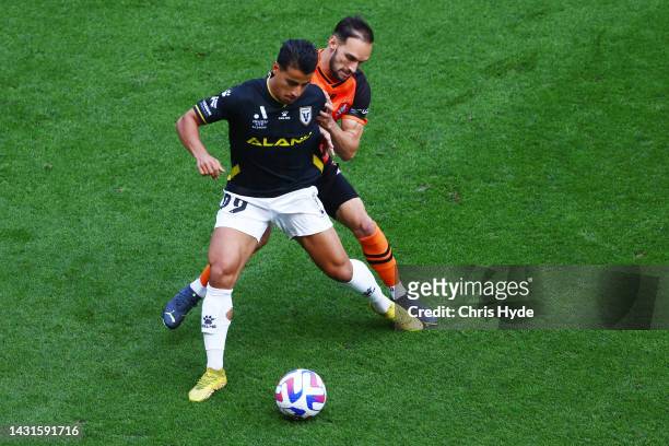 Daniel Arzani of Macarthur and Jack Hingert of the Roar compete for the ball during the round one A-League Men's match between Brisbane Roar and...