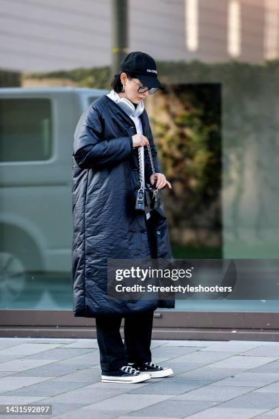 Influencer Maria Barteczko, wearing a black padded puffer coat by Wendykei, a white button down shirt by Wendykei, black skinny pants by Wendykei,...