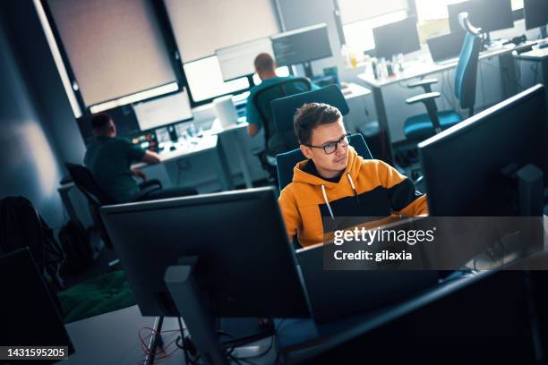 software developers at the office. - webdesigner stock pictures, royalty-free photos & images