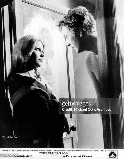Partially clad Margaret Blye looking up at Michael Caine in a scene from the film 'The Italian Job', 1969.