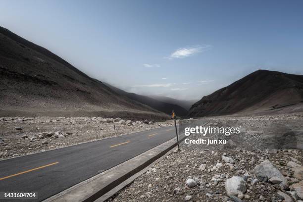 fast road under the clouds of mount ali qomolangma snow mountain in tibet - mount everest traffic stock pictures, royalty-free photos & images