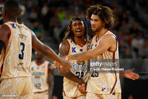 Keanu Pinder of the Taipans celebrates with Tahjere McCall of the Taipans and Shannon Scott of the Taipans during the round two NBL match between...