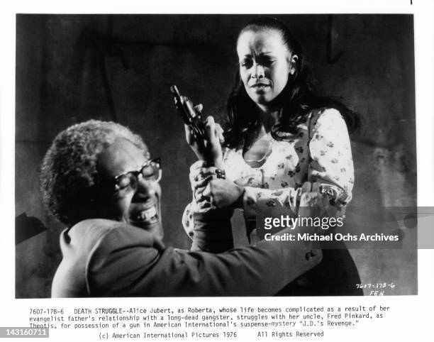 Fred Pinkhard and Alice Jubert struggle over gun in a scene from the film 'J.D.'s Revenge', 1976.