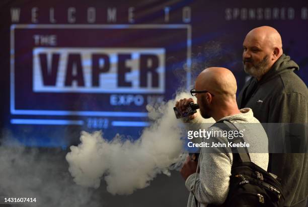 Visitors vape during the Vaper Expo at National Exhibition Centre on October 07, 2022 in Birmingham, England. The Vaper Expo UK is recognised as the...