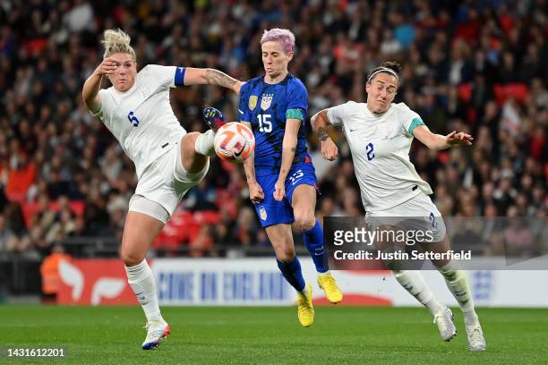 Millie Bright and Lucy Bronze of England battles for possession with Megan Rapinoe of United States during the Women's International Friendly match...