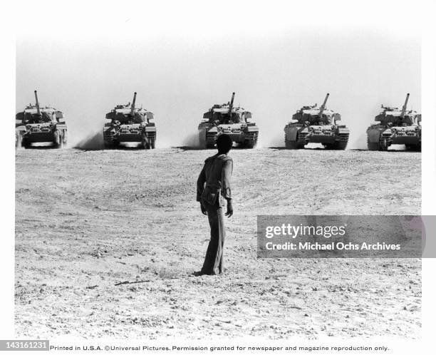 Four military tractors holding ammunition roll toward Carl Anderson in a scene from the film 'Jesus Christ Superstar', 1973.