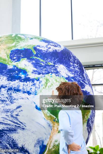 globe, global, model, child, boy, back view, pointing - alpha males stock pictures, royalty-free photos & images