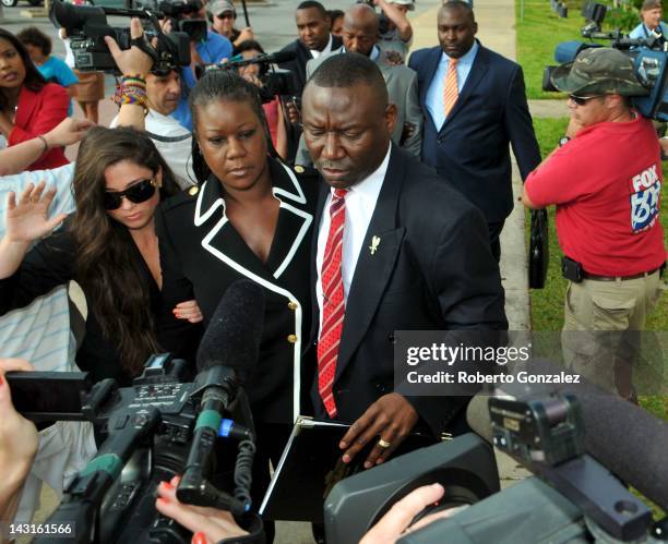 Sybrina Fulton , mother of Trayvon Martin, walks beside her attorney Benjamin Crump while the father Tracy Martin walks behind, as they enter...