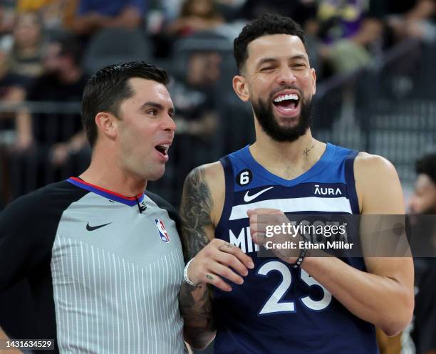Referee Andy Nagy and Austin Rivers of the Minnesota Timberwolves share a laugh during a break in the third quarter of a preseason game between the...