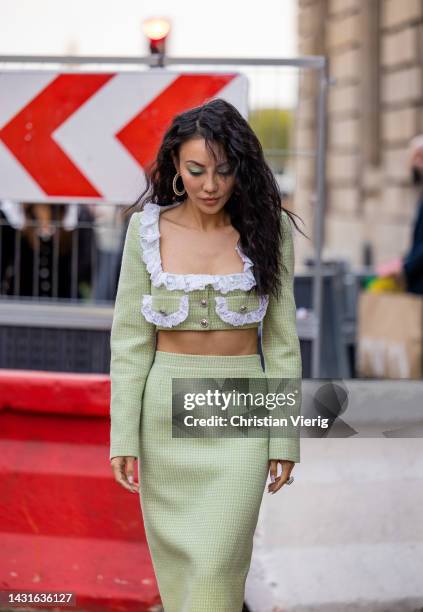 Jessica Wang wears green cropped jacket with ruffled white element, pockets, tube skirt, platform shoe outside Alessandra Rich during Paris Fashion...