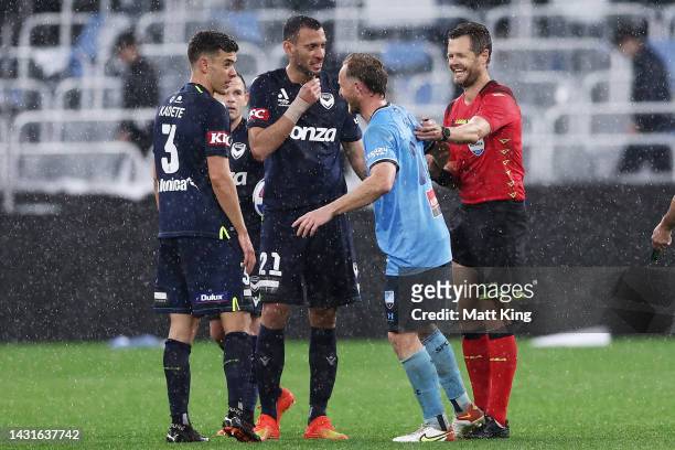 Referee Chris Beath and Rhyan Grant of Sydney FC embrace after colliding during the round one A-League Men's match between Sydney FC and Melbourne...