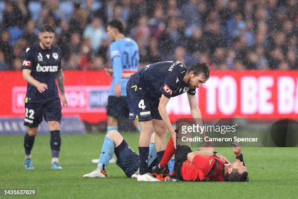 Referee Chris Beath receives attention after colliding with Rhyan Grant of Sydney FC during the round one A-League Men's match between Sydney FC and...
