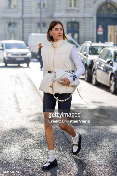 Vera van Erp wears latte vest, white long sleeved shirt, shorts, bag, socks, shoes outside Chanel during Paris Fashion Week - Womenswear...