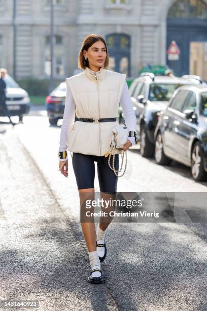 Vera van Erp wears latte vest, white long sleeved shirt, shorts, bag, socks, shoes outside Chanel during Paris Fashion Week - Womenswear...