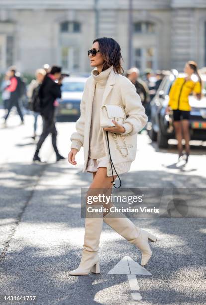 Golestaneh Mayer-Uellner wears Creme bomber jacket - Chanel, Turtleneck pullover - Celine, Shorts - Isabel Marant, Bag - Chanel, Overknee boots -...