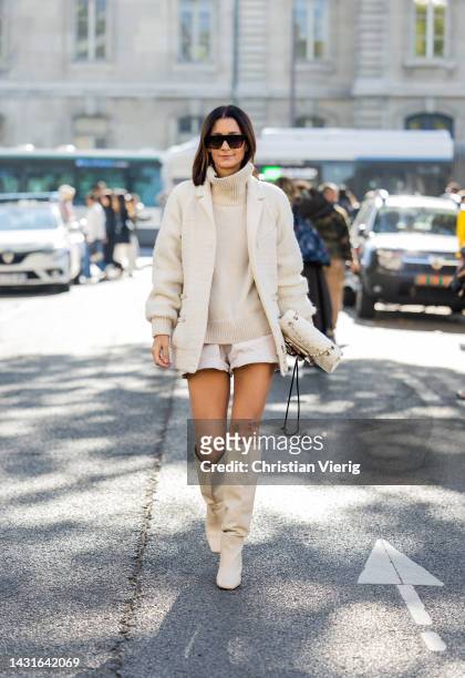 Golestaneh Mayer-Uellner wears Creme bomber jacket - Chanel, Turtleneck pullover - Celine, Shorts - Isabel Marant, Bag - Chanel, Overknee boots -...