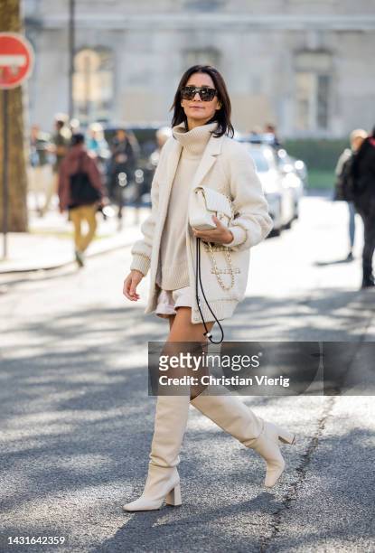 Golestaneh Mayer-Uellner wears Creme bomber jacket - Chanel, Turtleneck pullover - Celine, Shorts - Isabel Marant, Bag - Chanel, Overknee boots -...